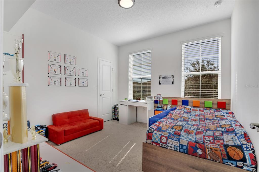 15807 Sweet Lemon Way Winter Garden, FL 34787 - Photo 25 of 35 a bedroom with bed and window