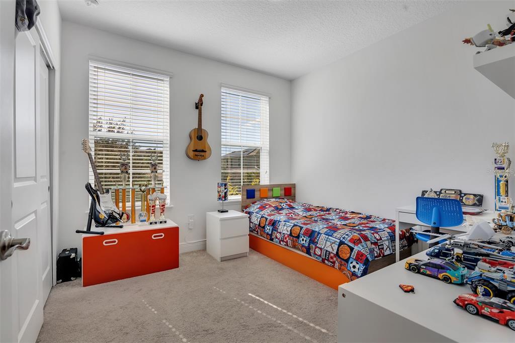 15807 Sweet Lemon Way Winter Garden, FL 34787 - Photo 26 of 35 a bedroom with two beds and a window