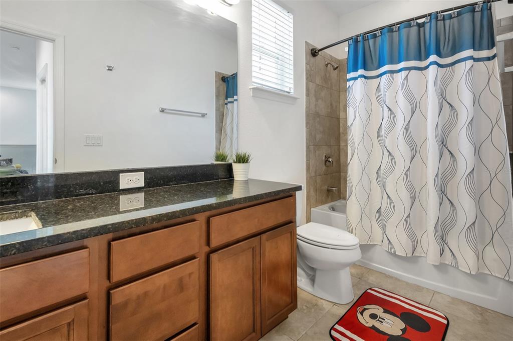 15807 Sweet Lemon Way Winter Garden, FL 34787 - Photo 28 of 35 a bathroom with a sink a toilet and a shower curtain