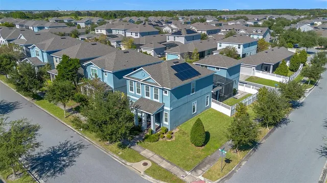 an aerial view of residential house with outdoor space and swimming pool