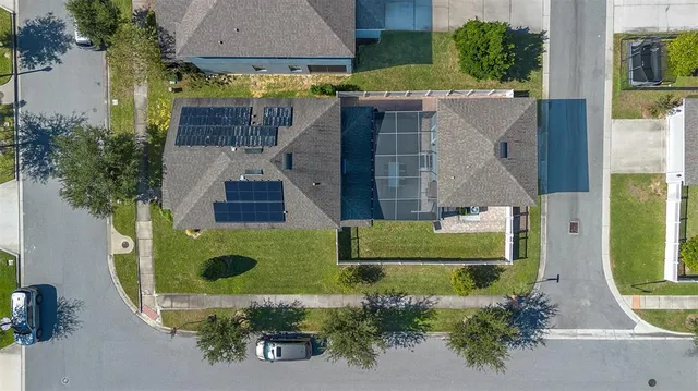 an aerial view of a house with a yard