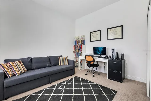 a living room with furniture a flat screen tv and a window