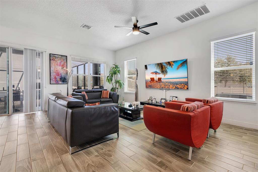 15807 Sweet Lemon Way Winter Garden, FL 34787 - Photo 7 of 35 a living room with furniture window and a flat screen tv