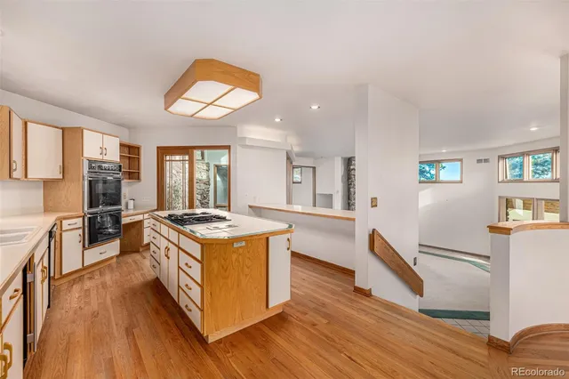 a bathroom with a granite countertop tub sink and large window