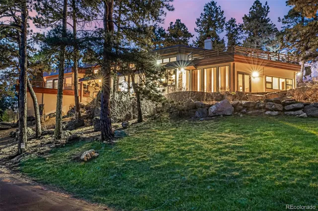 a view of a house with backyard sitting area and garden