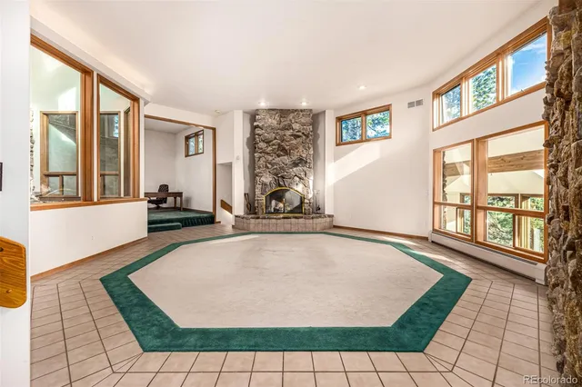 a bedroom with a bed and painting on the wall