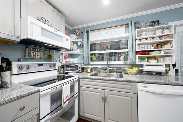 a kitchen with stainless steel appliances granite countertop a sink and cabinets