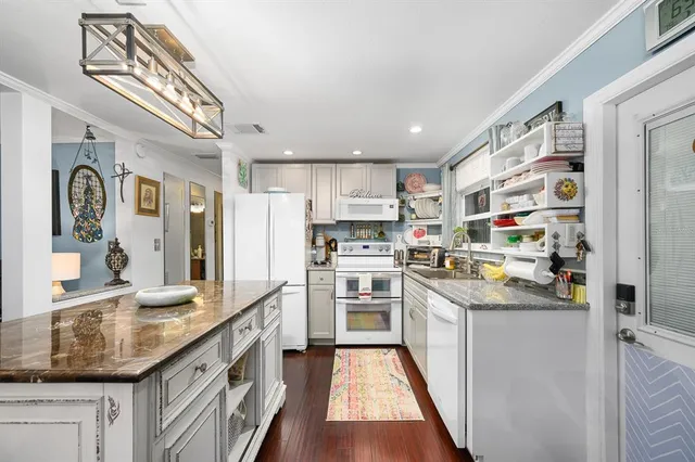 a kitchen with stainless steel appliances granite countertop a sink and cabinets
