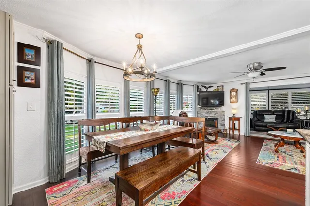 a living room with furniture a flat screen tv and a large window