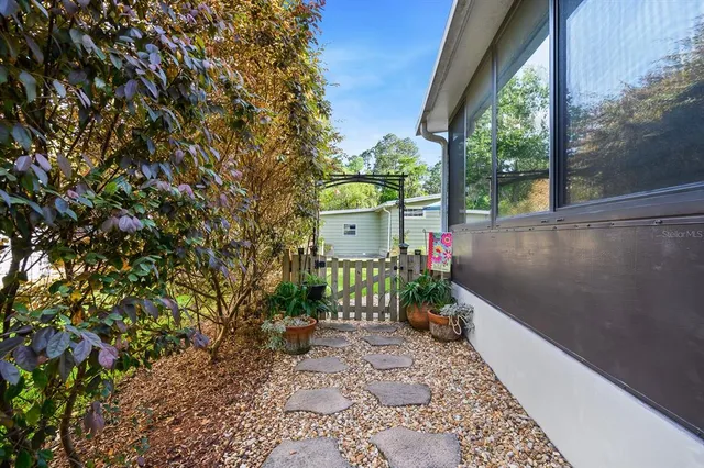 a view of a patio with table and chairs potted plants with wooden fence