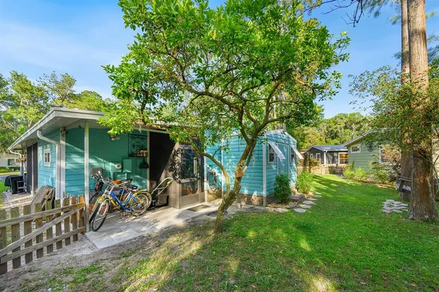 a view of a backyard with swimming pool and trees in the background