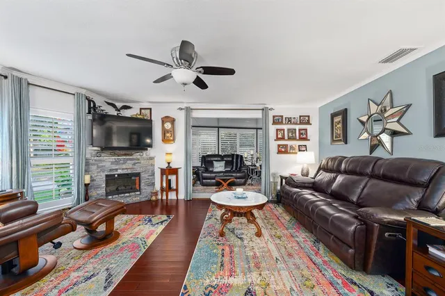 a living room with furniture fireplace and flat screen tv