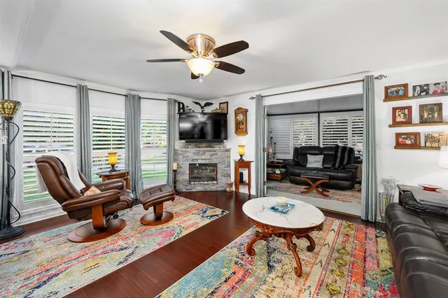 a living room with furniture a rug and a flat screen tv