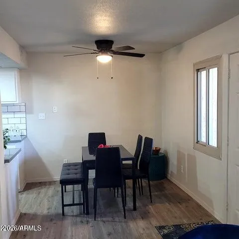 a view of a workspace room with furniture and wooden floor