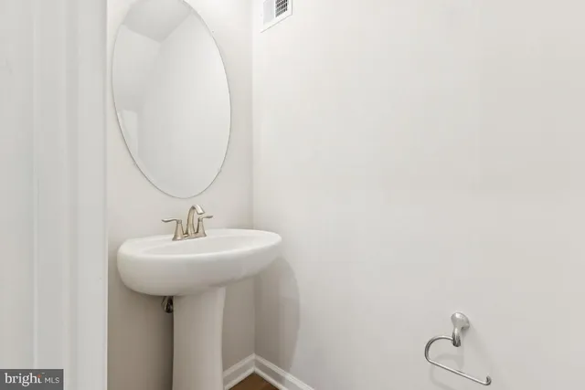 a bathroom with a sink and mirror