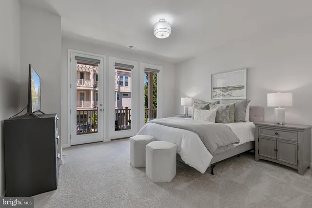 a spacious bedroom with a bed and a flat screen television