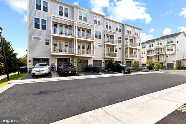 a buildings with car parked in front of it