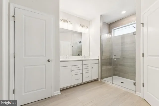 a bathroom with a shower sink and mirror