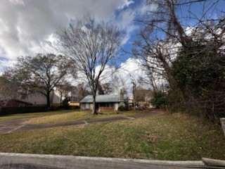 1235 West 25th Street Houston, TX 77008 - Photo 2 of 8 a view of a yard with a house and trees