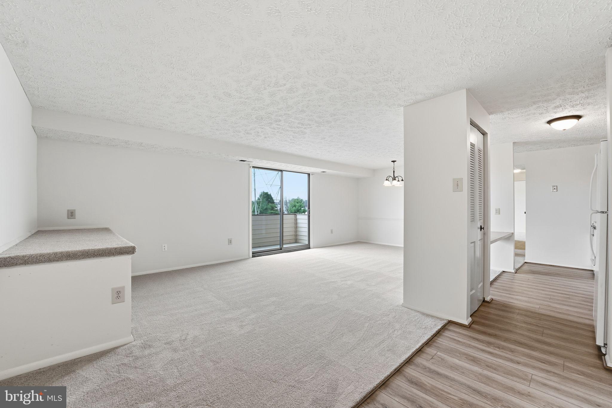 997 Heather Ridge Drive, Unit 3G Frederick, MD 21702 - Photo 1 of 14 a view of an empty room with wooden floor and a window