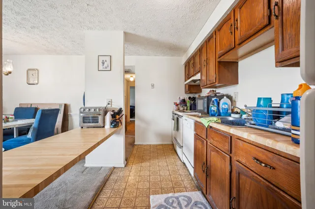 a kitchen with stainless steel appliances granite countertop a sink and cabinets