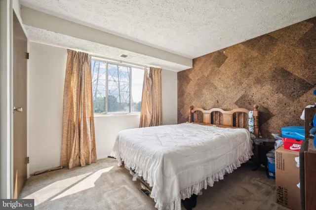 a bedroom with bed and a window