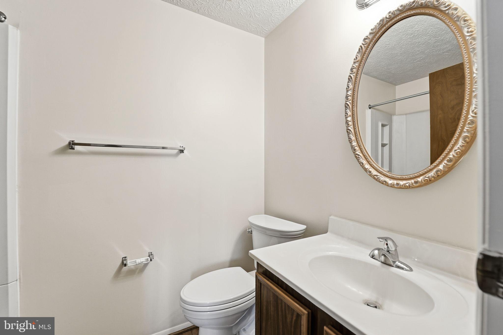 997 Heather Ridge Drive, Unit 3G Frederick, MD 21702 - Photo 9 of 14 a bathroom with a sink a mirror and a toilet