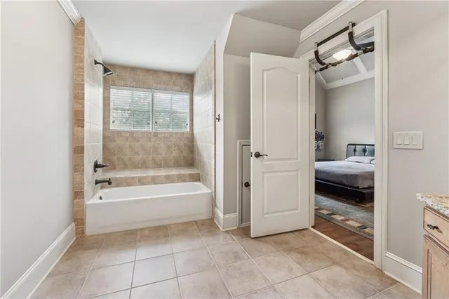 a bathroom with a granite countertop double vanity sink and a mirror