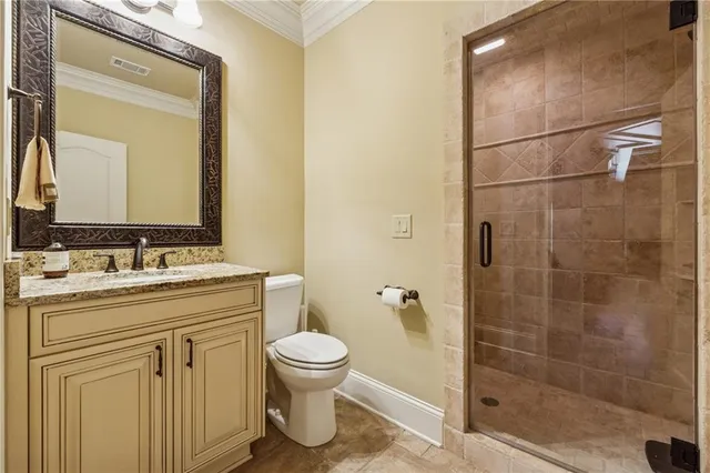 a bathroom with a granite countertop sink a toilet and a mirror