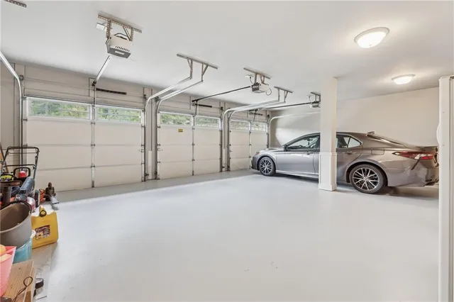 a front view of a house with a garden and trees