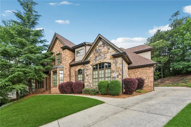a front view of a house with a garden