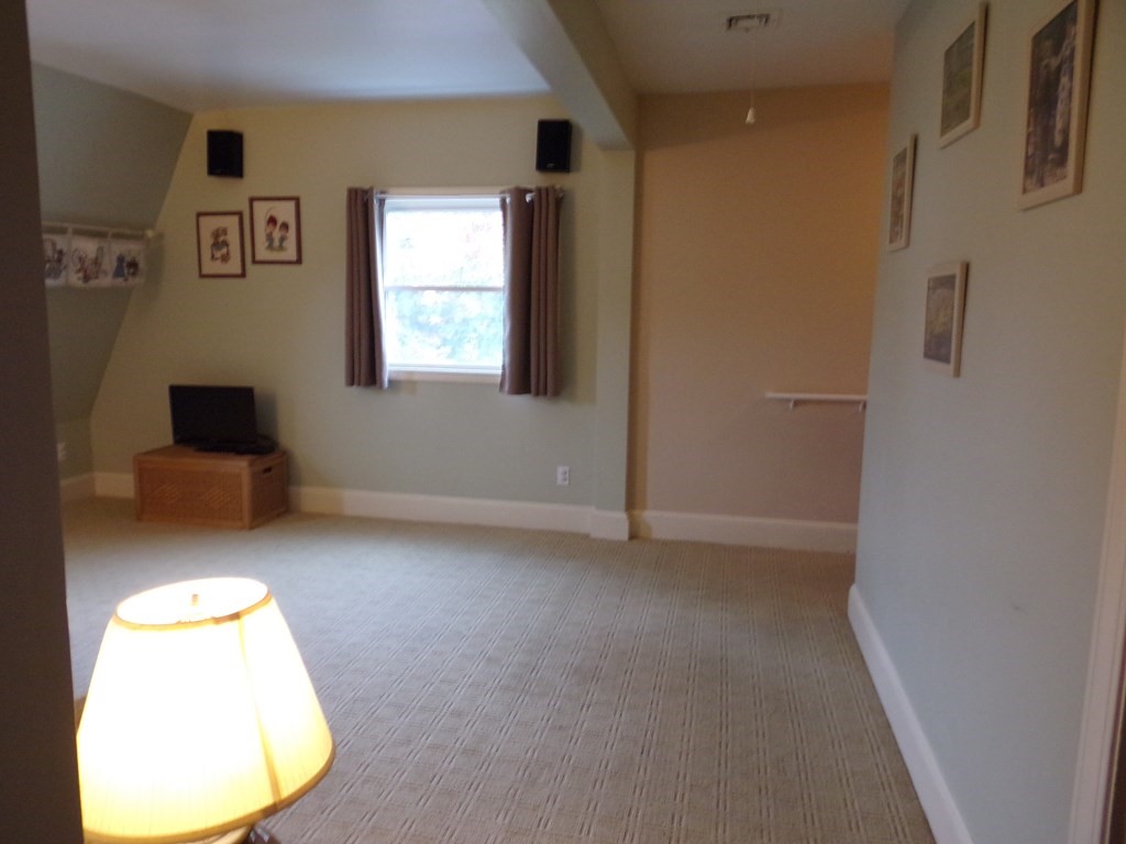 74 James Street Acushnet, MA 02743 - Photo 16 of 41 a view of a livingroom with a chair and a potted plant