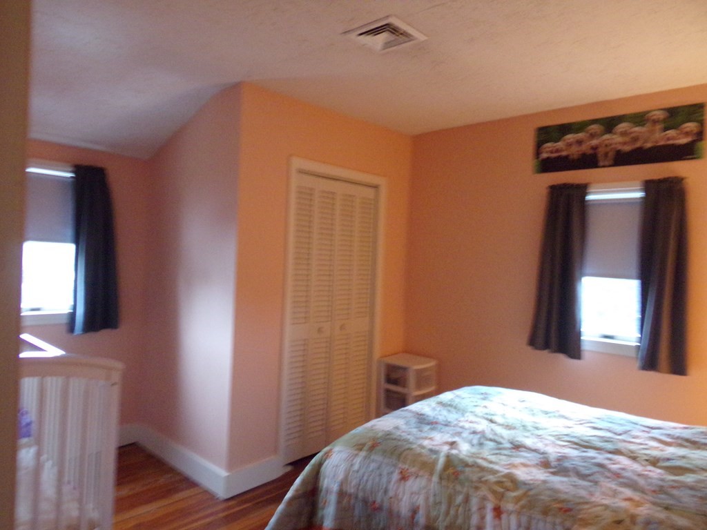 74 James Street Acushnet, MA 02743 - Photo 22 of 41 a bedroom with a bed and wooden floor