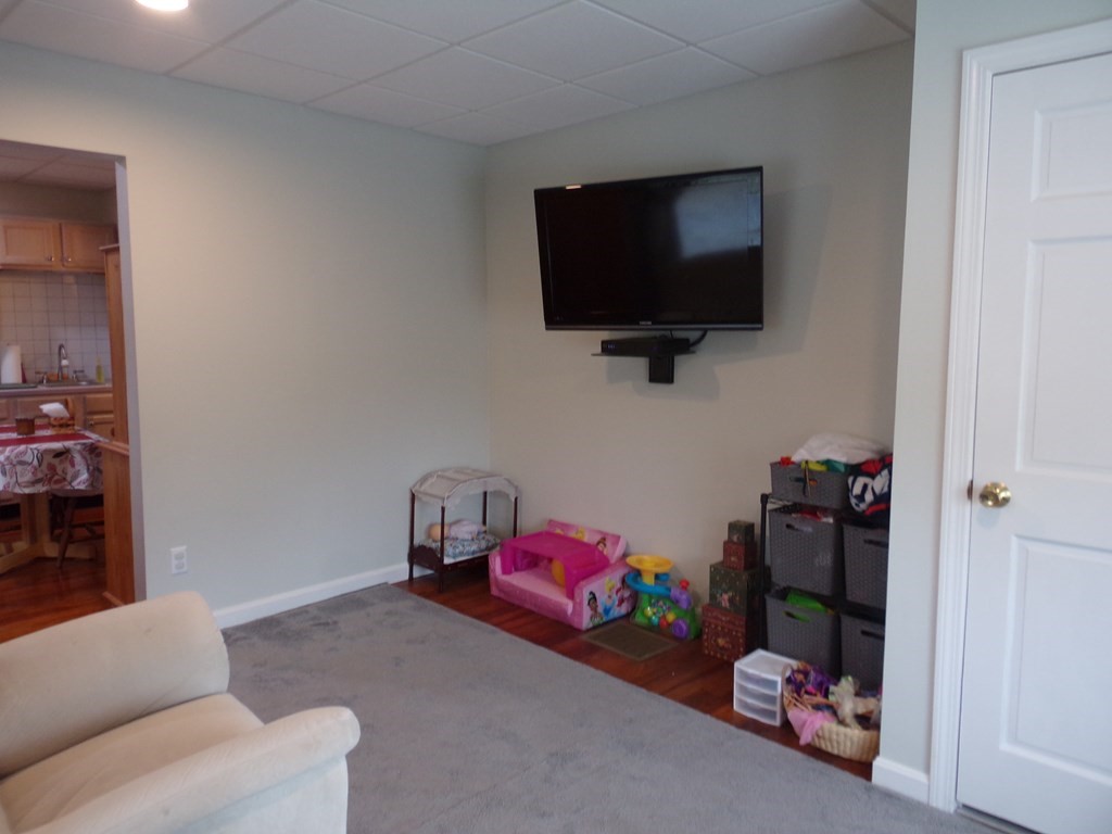 74 James Street Acushnet, MA 02743 - Photo 30 of 41 a living room with furniture and a flat screen tv