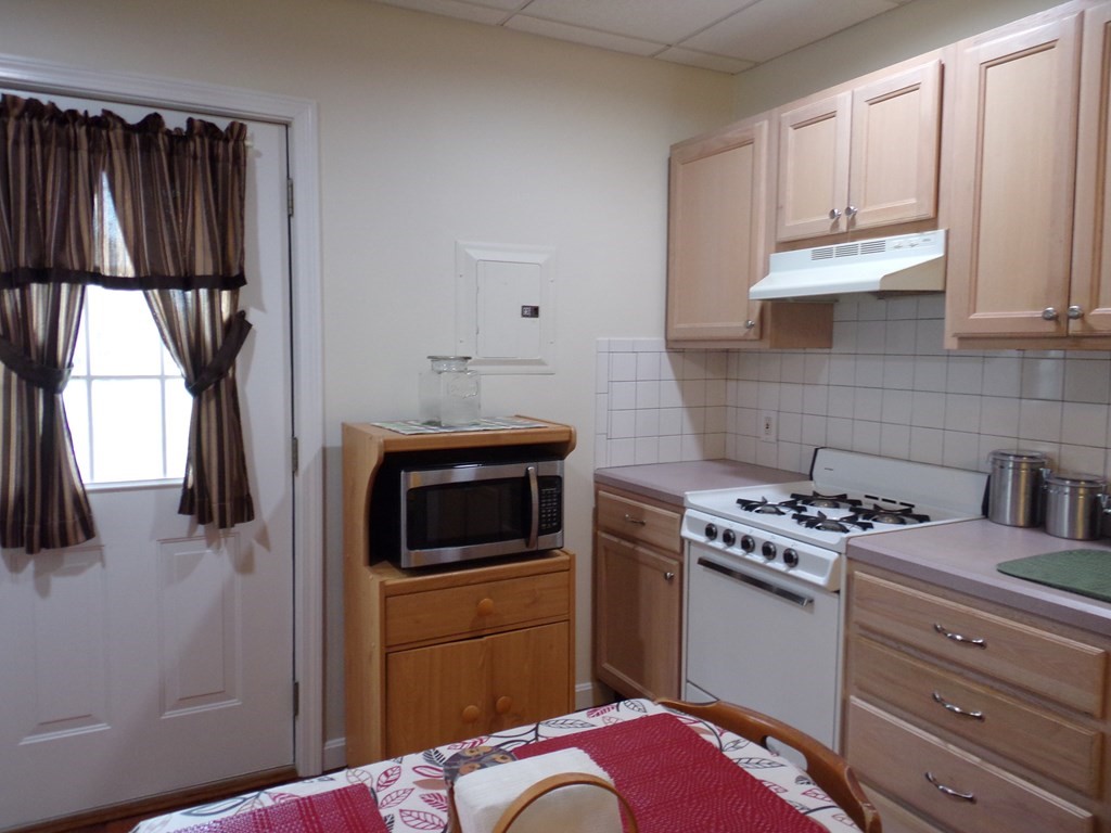 74 James Street Acushnet, MA 02743 - Photo 35 of 41 a kitchen with a stove and a microwave