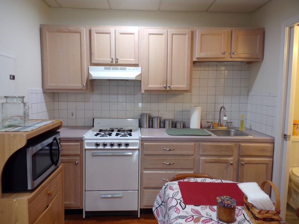 74 James Street Acushnet, MA 02743 - Photo 36 of 41 a kitchen with a stove sink and cabinets