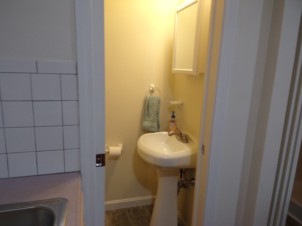 74 James Street Acushnet, MA 02743 - Photo 39 of 41 a bathroom with a sink and mirror
