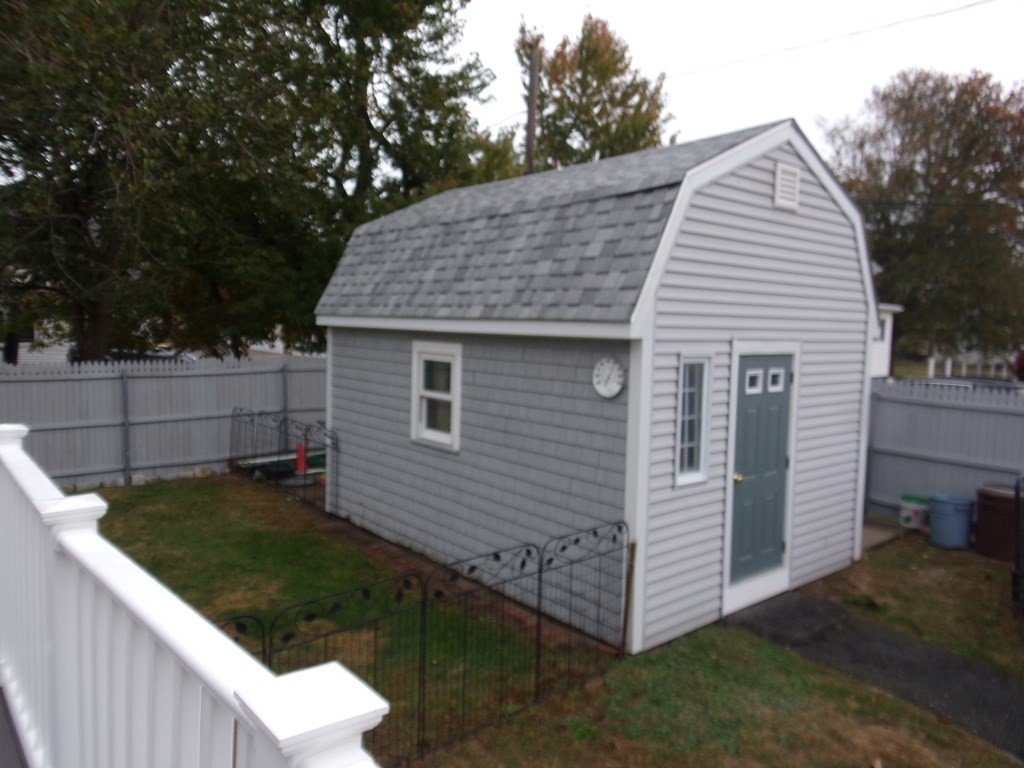 74 James Street Acushnet, MA 02743 - Photo 5 of 41 a view of a white house with a small yard and a large tree
