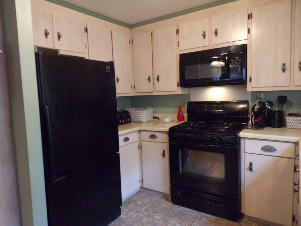 74 James Street Acushnet, MA 02743 - Photo 10 of 41 a kitchen with stainless steel appliances granite countertop cabinets and a stove top oven