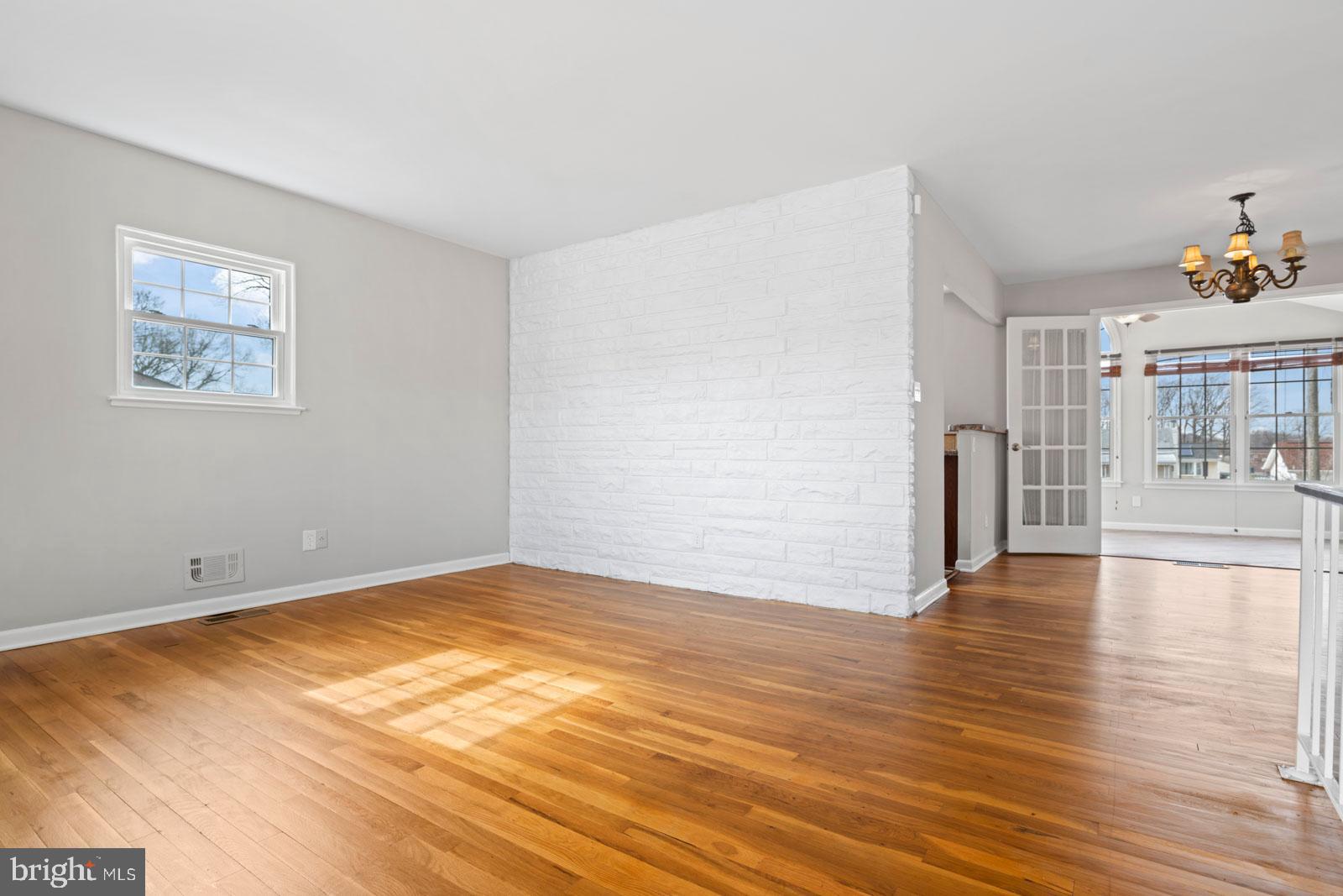 516 Nollmeyer Road Baltimore, MD 21220 - Photo 15 of 67 a view of an empty room with wooden floor and a kitchen