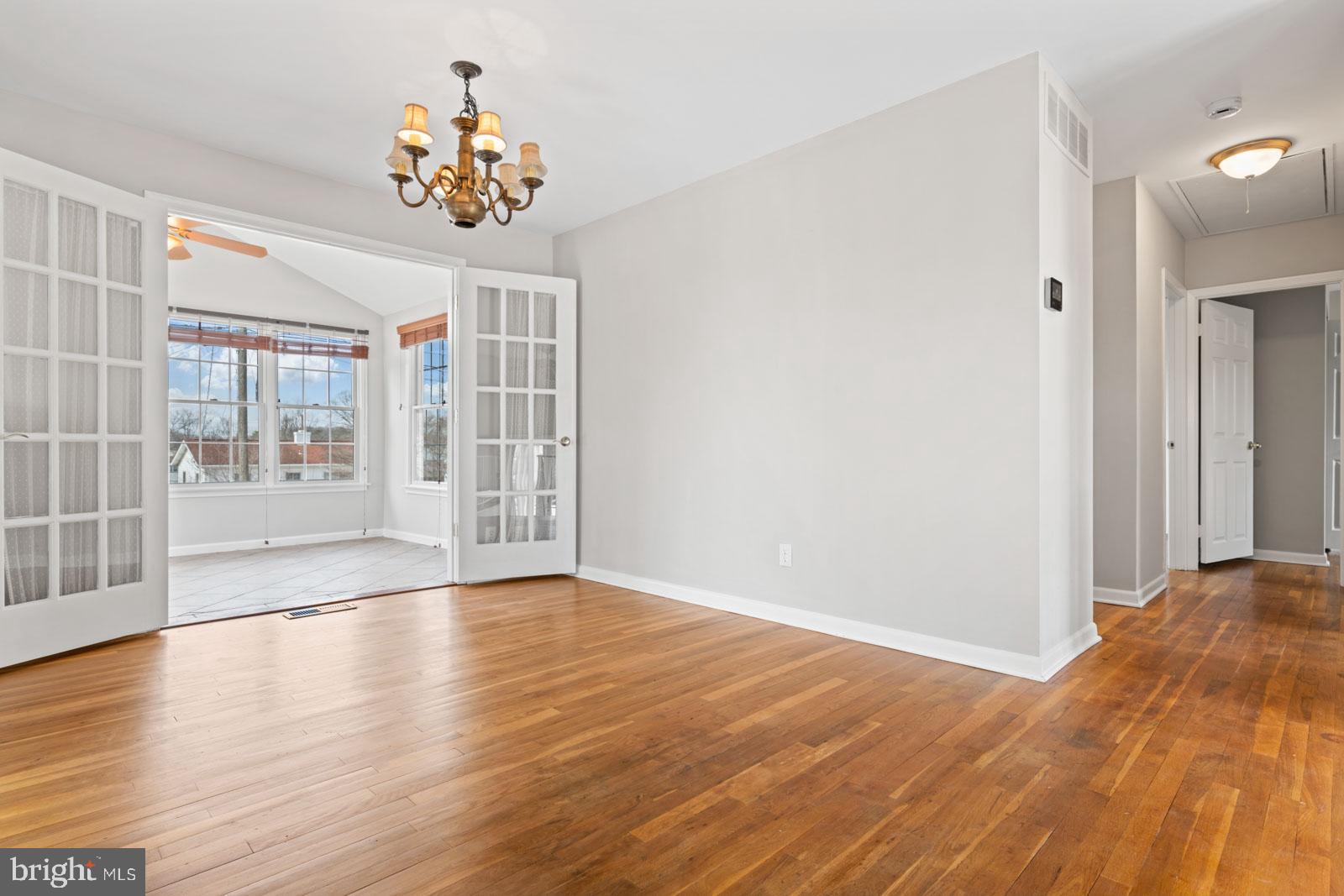 516 Nollmeyer Road Baltimore, MD 21220 - Photo 17 of 67 a view of an empty room with wooden floor and a window