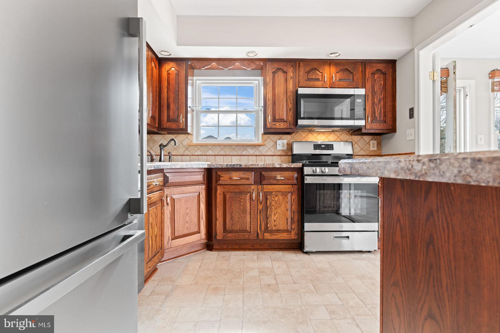 516 Nollmeyer Road Baltimore, MD 21220 - Photo 21 of 67 a kitchen with a stove top oven sink and cabinets