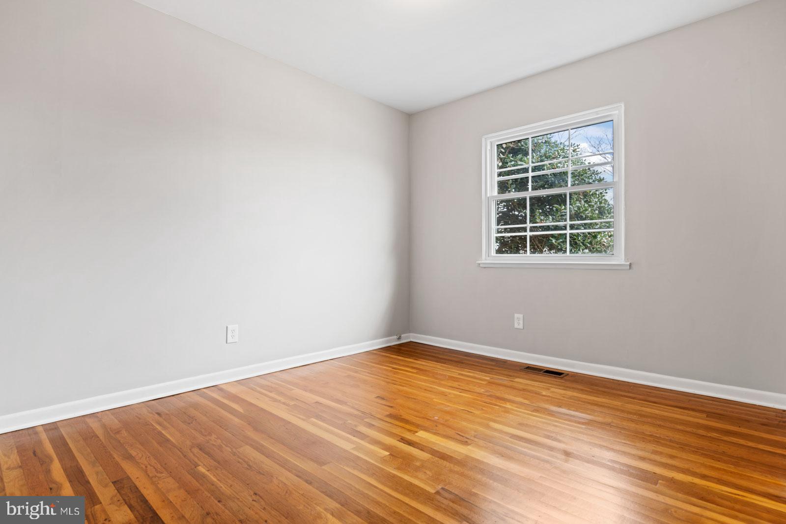 516 Nollmeyer Road Baltimore, MD 21220 - Photo 40 of 67 an empty room with wooden floor and windows
