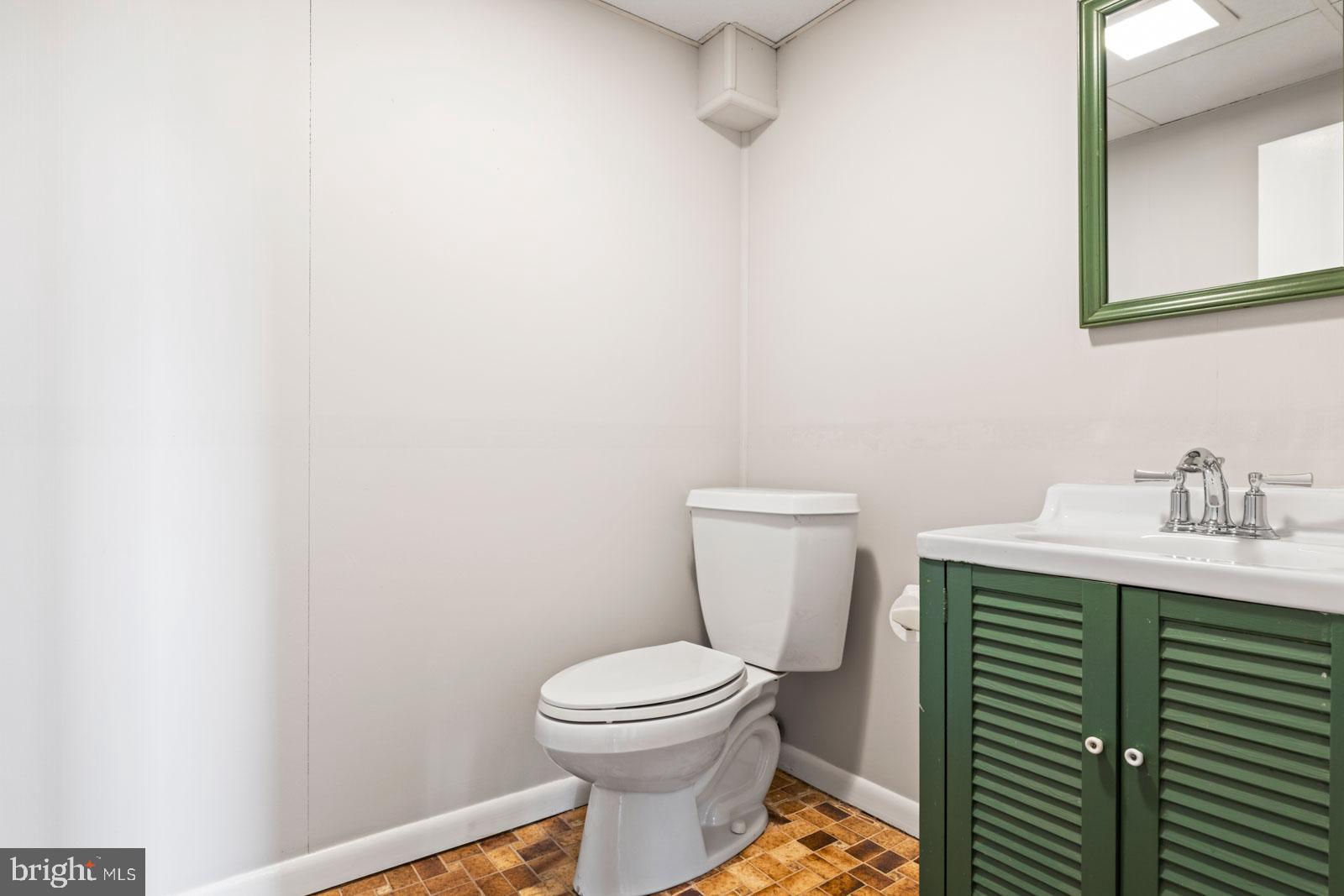 516 Nollmeyer Road Baltimore, MD 21220 - Photo 48 of 67 a bathroom with a toilet a sink and mirror