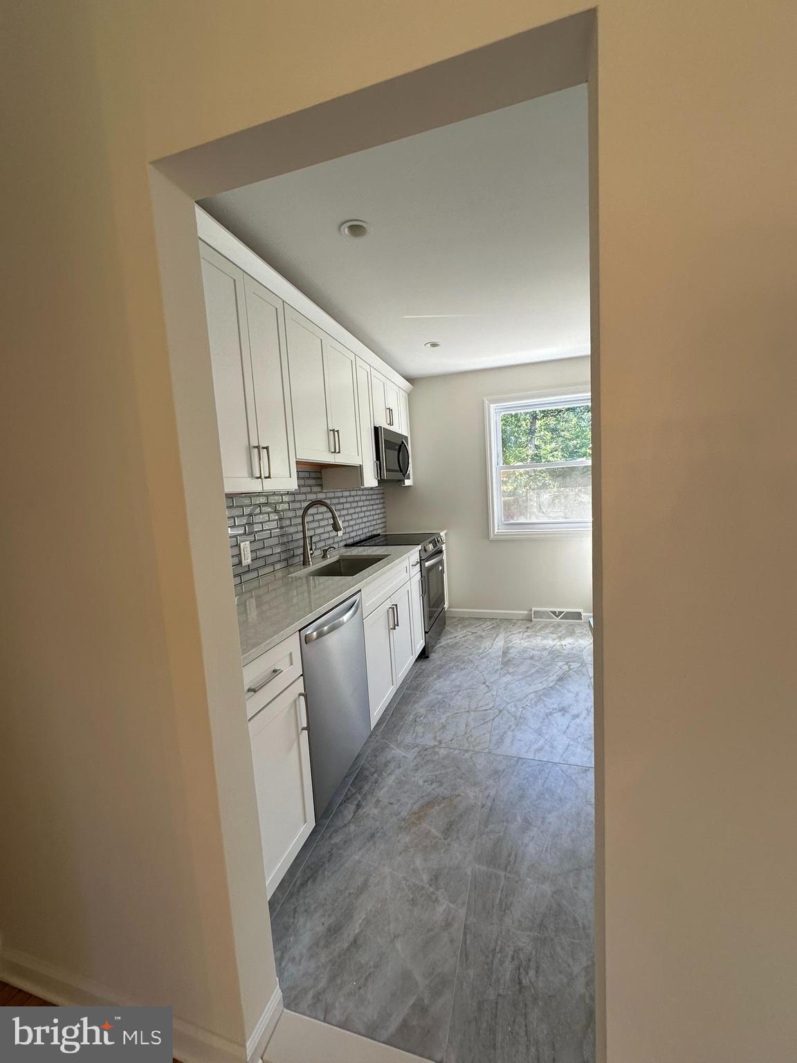 291 Union Street Glassboro, NJ 08028 - Photo 15 of 60 a kitchen with a sink a window and cabinets