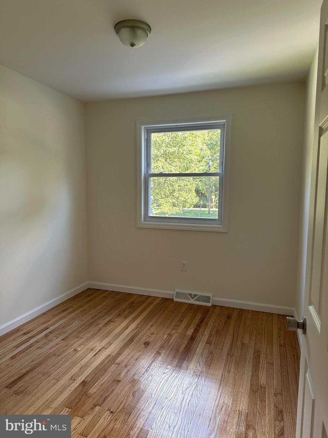 291 Union Street Glassboro, NJ 08028 - Photo 18 of 60 an empty room with wooden floor and windows