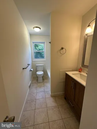 a white toilet sitting next to a bathroom sink