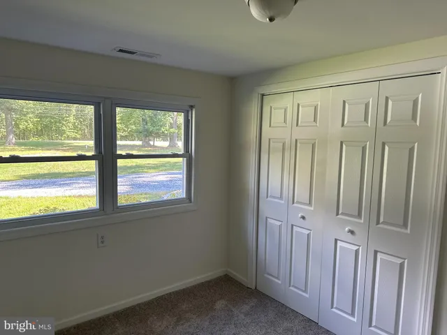 a view of hallway with window and a fireplace