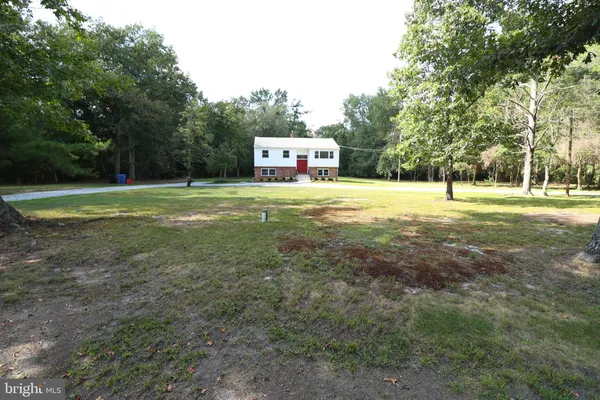 a view of a house with backyard and porch