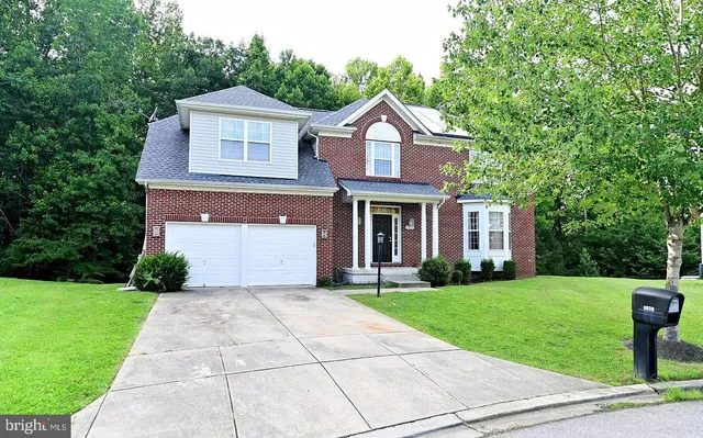 a front view of a house with yard
